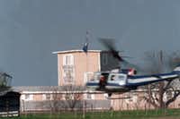 A helicopter buzzes past the compound on March 27. A new sign was draped out the tower window which read "Rodney King we understand."&nbsp;(David Phillip/The Associated Press)